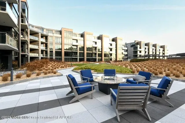 a view of a patio with a table and chairs and potted plants