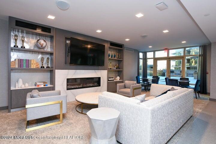 30 Melrose Terrace, Unit 201 Long Branch, NJ 07740 - Photo 26 of 33 a living room with fireplace furniture and a flat screen tv