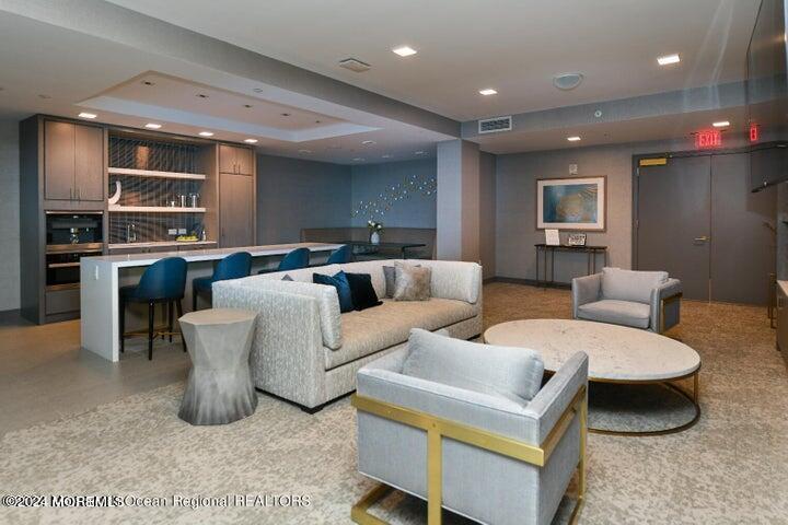 30 Melrose Terrace, Unit 201 Long Branch, NJ 07740 - Photo 29 of 33 a living room with furniture a large window and kitchen view