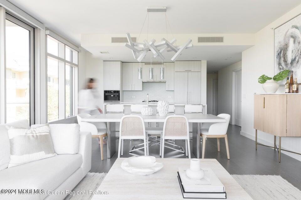 30 Melrose Terrace, Unit 201 Long Branch, NJ 07740 - Photo 4 of 33 a view of a dining room with furniture and wooden floor