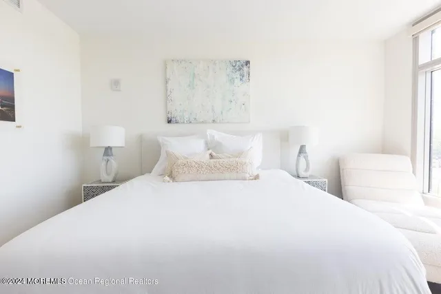 a bedroom with a bed and a lamp