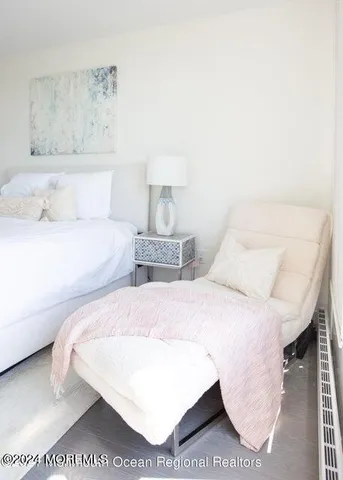 a bedroom with a bed and a night stand