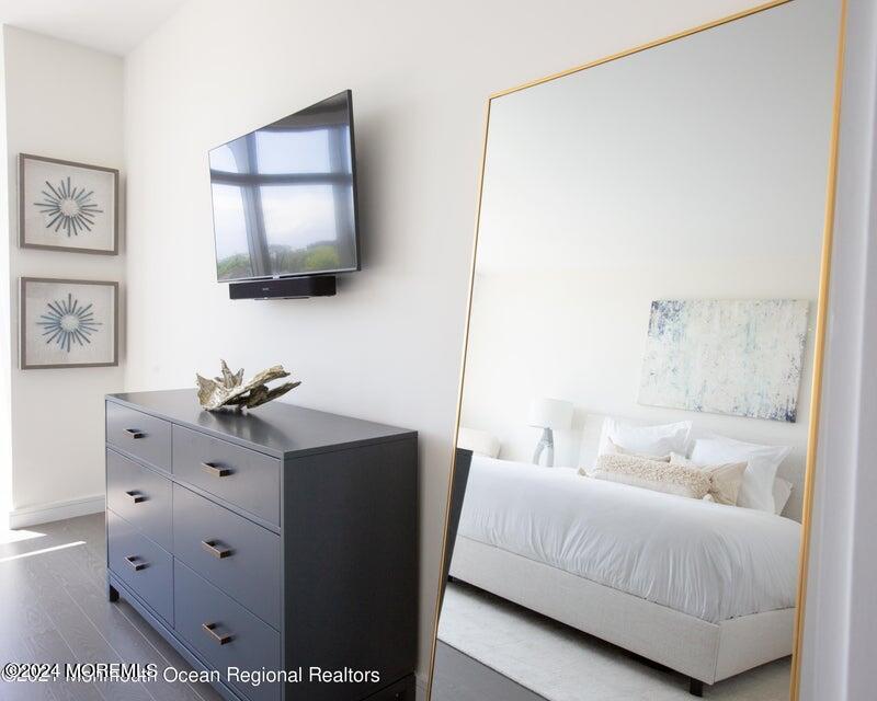 30 Melrose Terrace, Unit 201 Long Branch, NJ 07740 - Photo 8 of 33 a living room with furniture and a flat screen tv