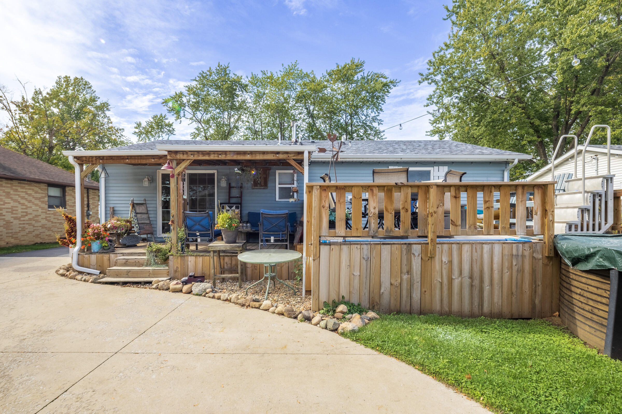 655 Fairview Street Westville, IN 46391 - Photo 21 of 25 a view of a dinning table and chairs in patio with wooden fence