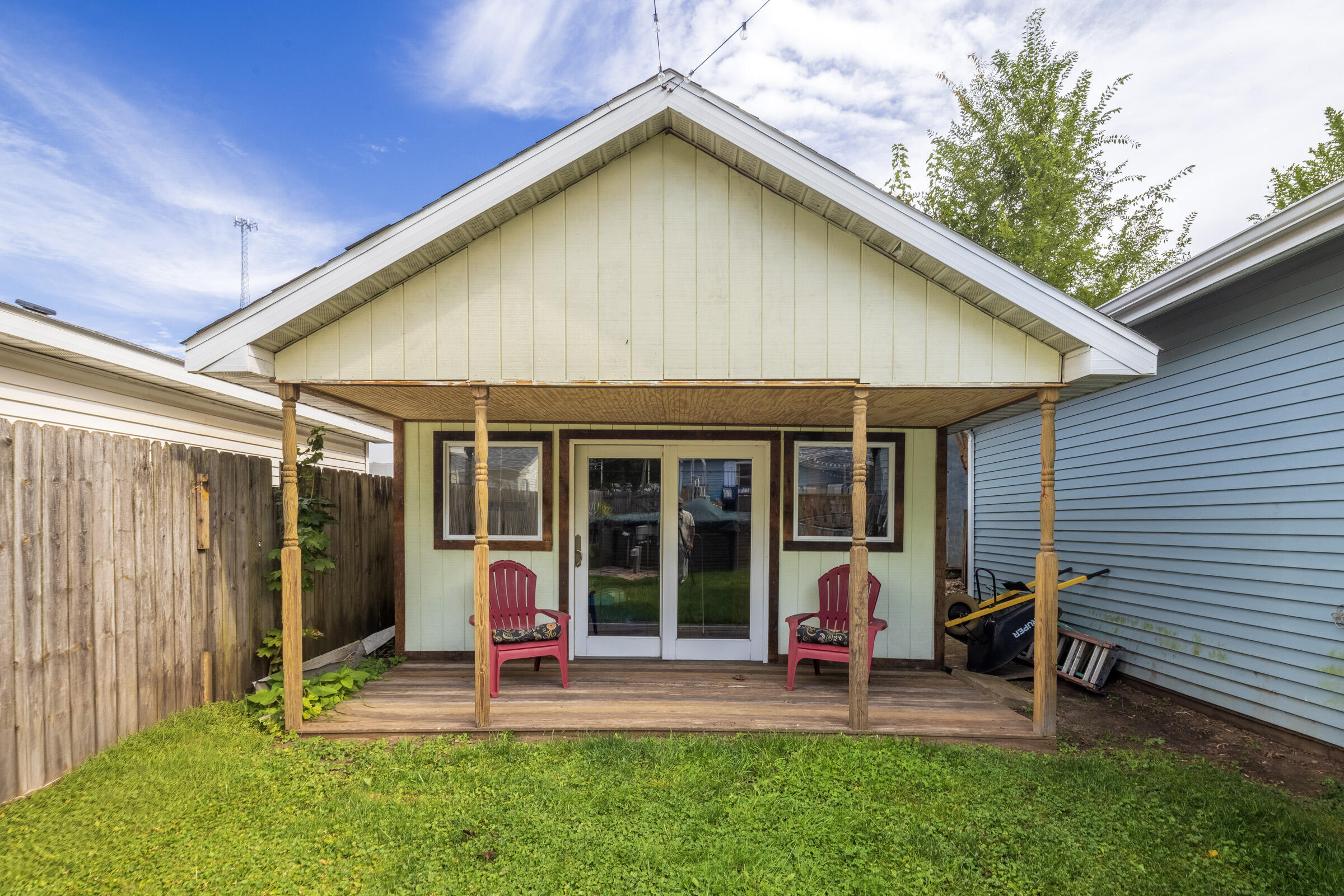 655 Fairview Street Westville, IN 46391 - Photo 23 of 25 a view of a house that has a table and chairs and floor to ceiling window with wooden fence