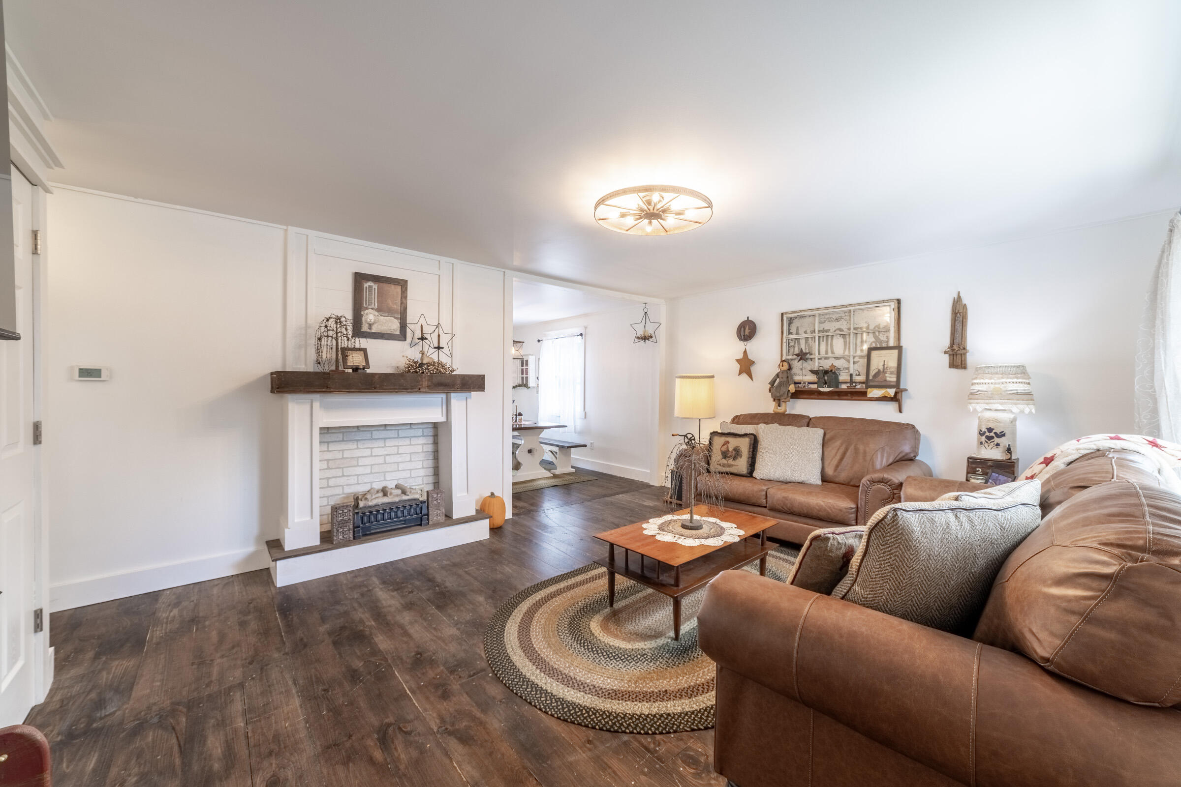 655 Fairview Street Westville, IN 46391 - Photo 4 of 25 a living room with furniture a fireplace and a flat screen tv