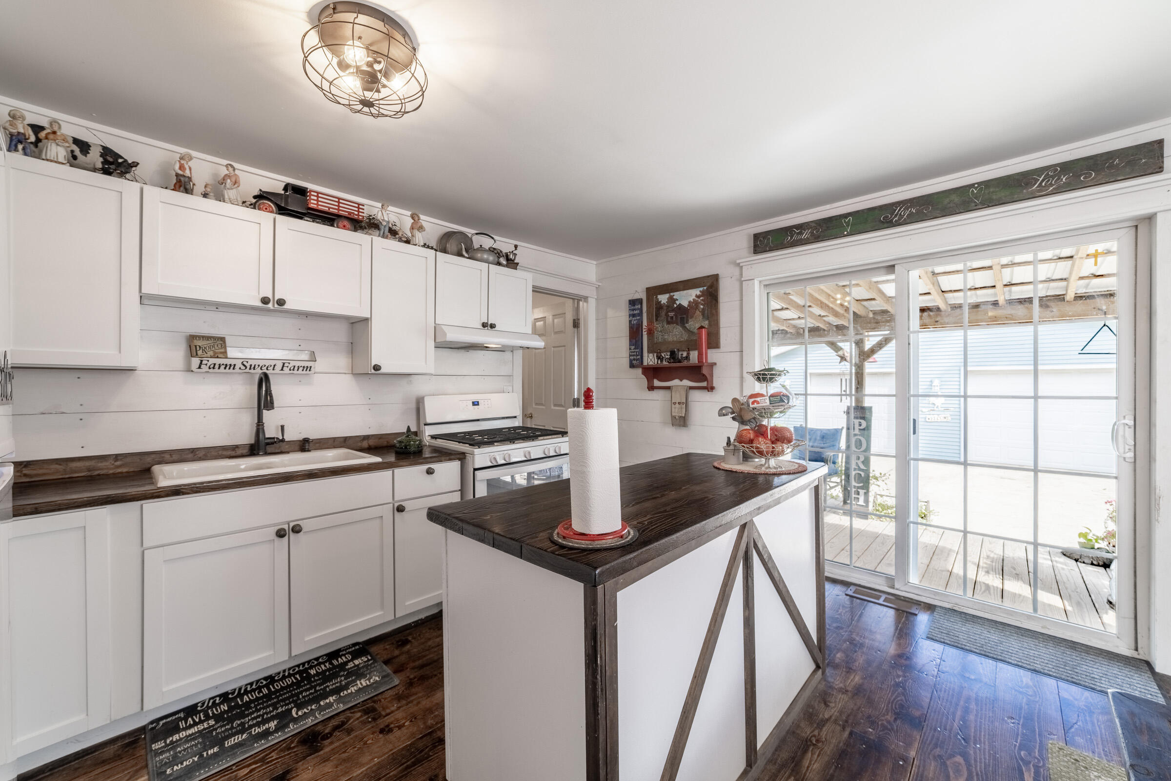 655 Fairview Street Westville, IN 46391 - Photo 8 of 25 a kitchen with stainless steel appliances granite countertop a stove a sink dishwasher and a refrigerator with wooden floor