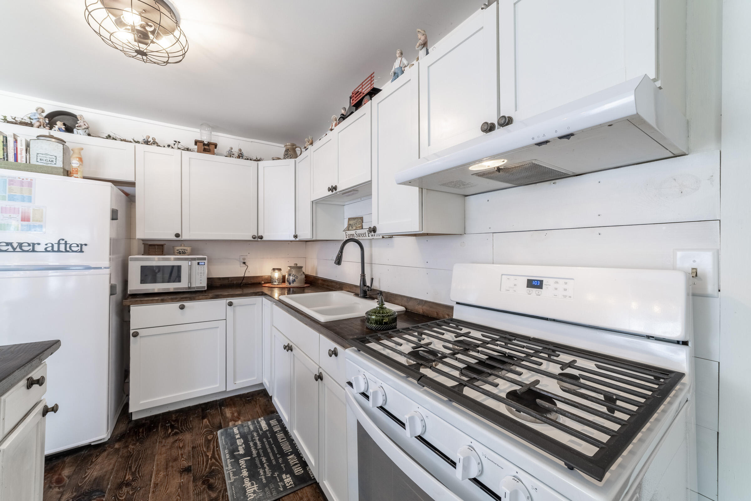 655 Fairview Street Westville, IN 46391 - Photo 9 of 25 a kitchen with white cabinets and appliances