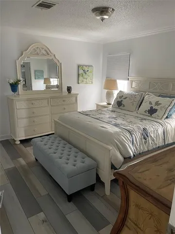 a bedroom with a bed and a dresser