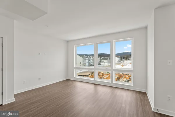 wooden floor in an empty room with window