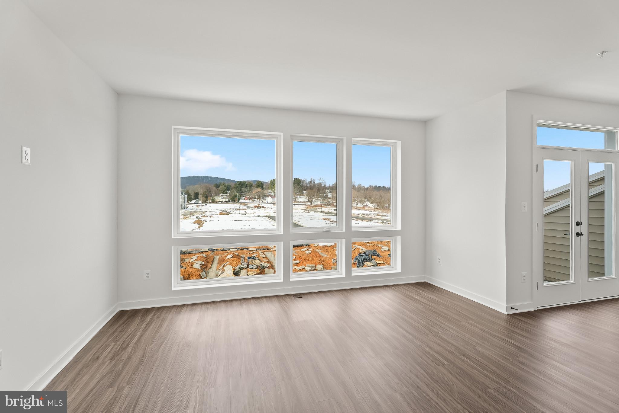 714 D Iron Frg Road Frederick, MD 21702 - Photo 14 of 47 an empty room with wooden floor and windows