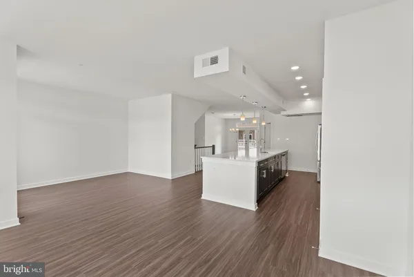 a view of kitchen and hall with wooden floor
