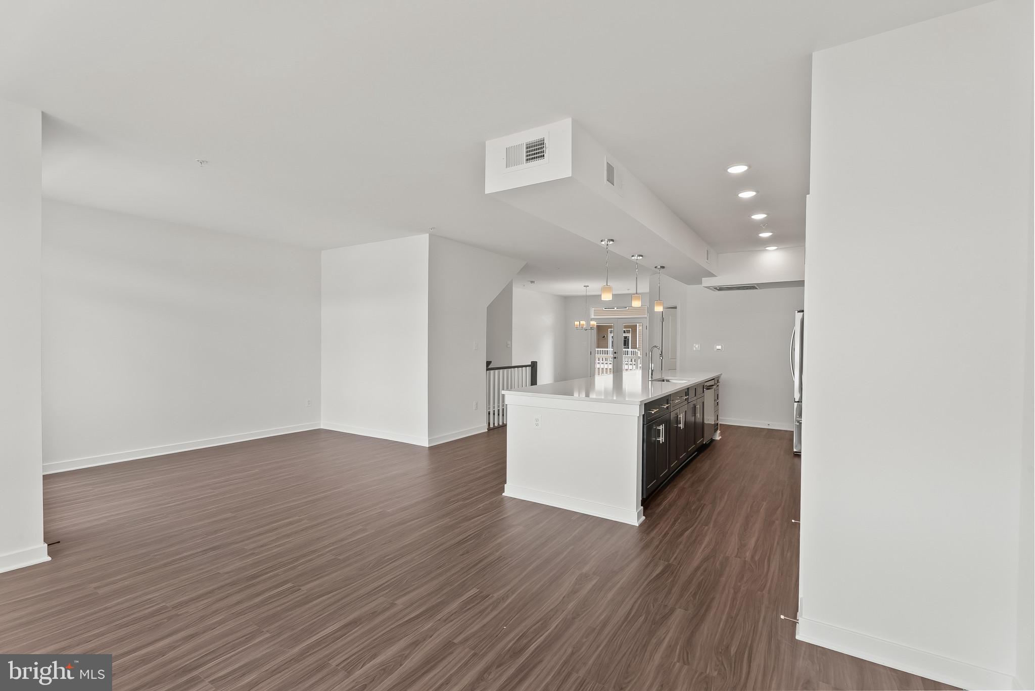 714 D Iron Frg Road Frederick, MD 21702 - Photo 15 of 47 a view of kitchen and hall with wooden floor
