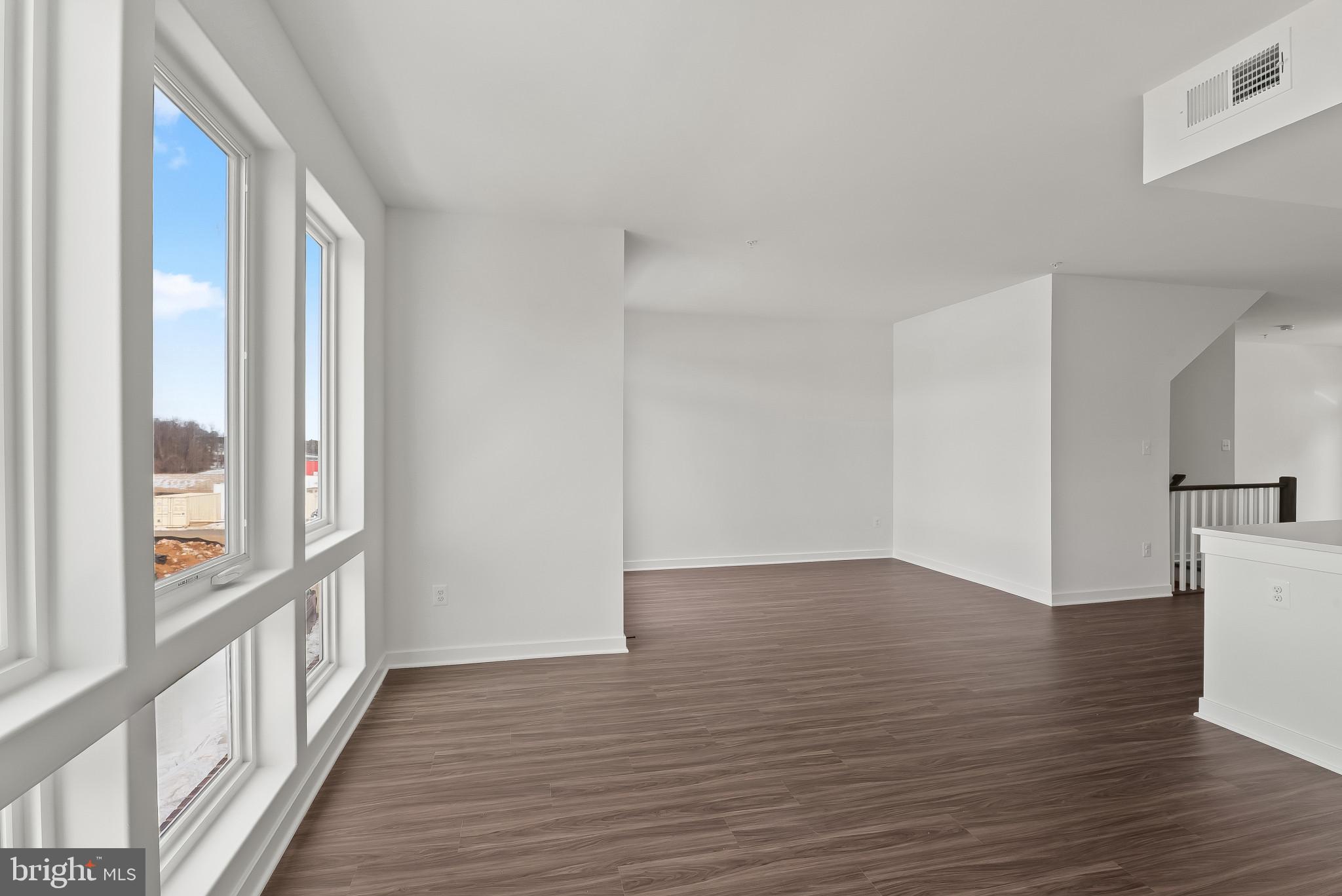 714 D Iron Frg Road Frederick, MD 21702 - Photo 17 of 47 a view of an empty room with wooden floor and a window