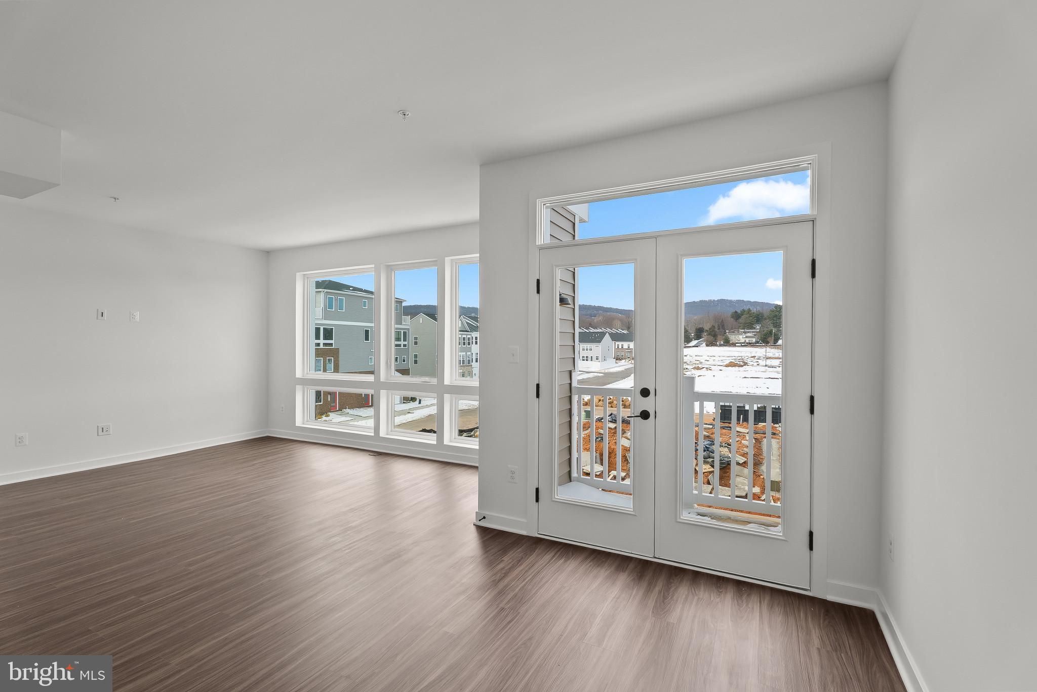 714 D Iron Frg Road Frederick, MD 21702 - Photo 19 of 47 a view of an empty room with wooden floor and a window