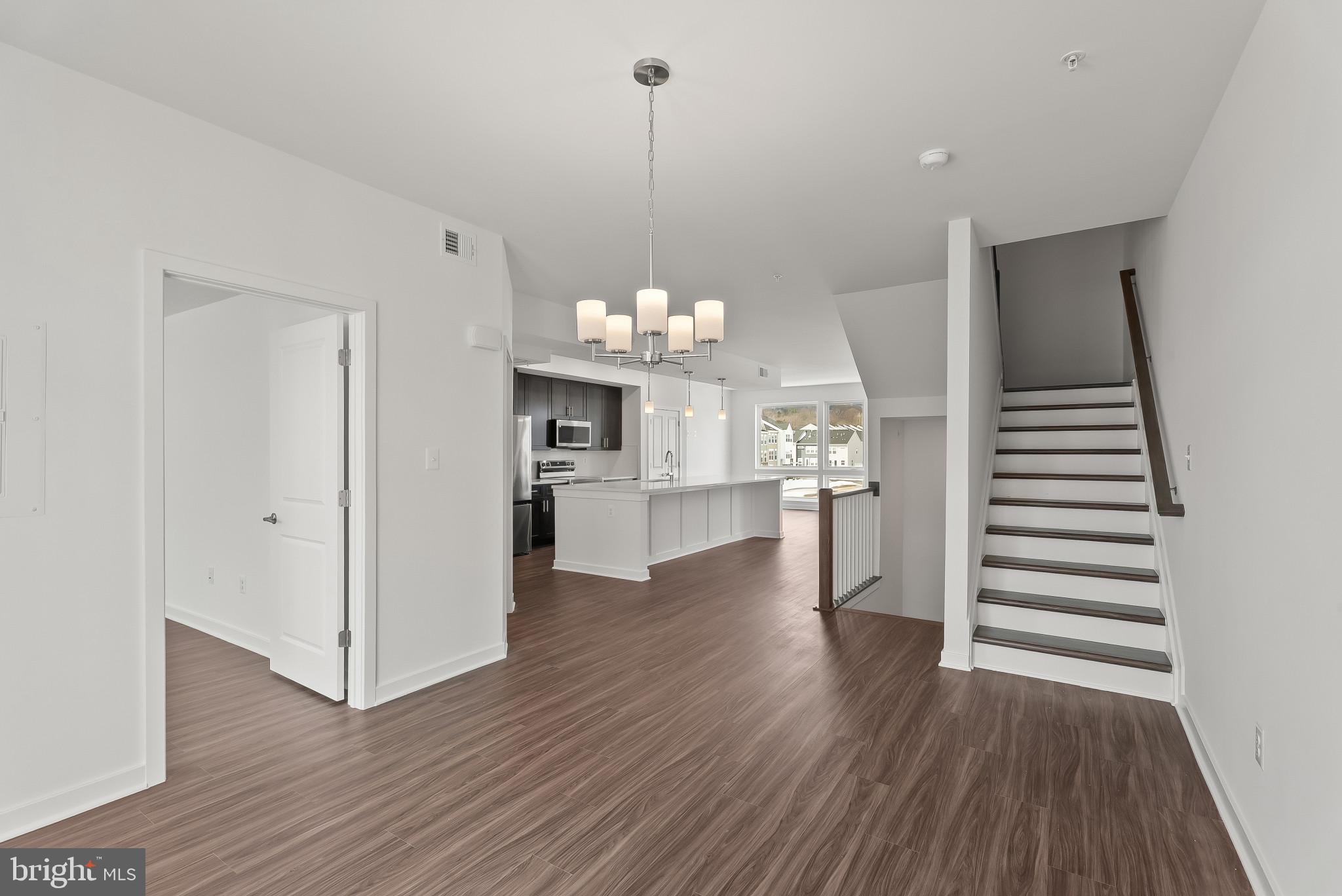 714 D Iron Frg Road Frederick, MD 21702 - Photo 23 of 47 a view of a room with wooden floor and kitchen view