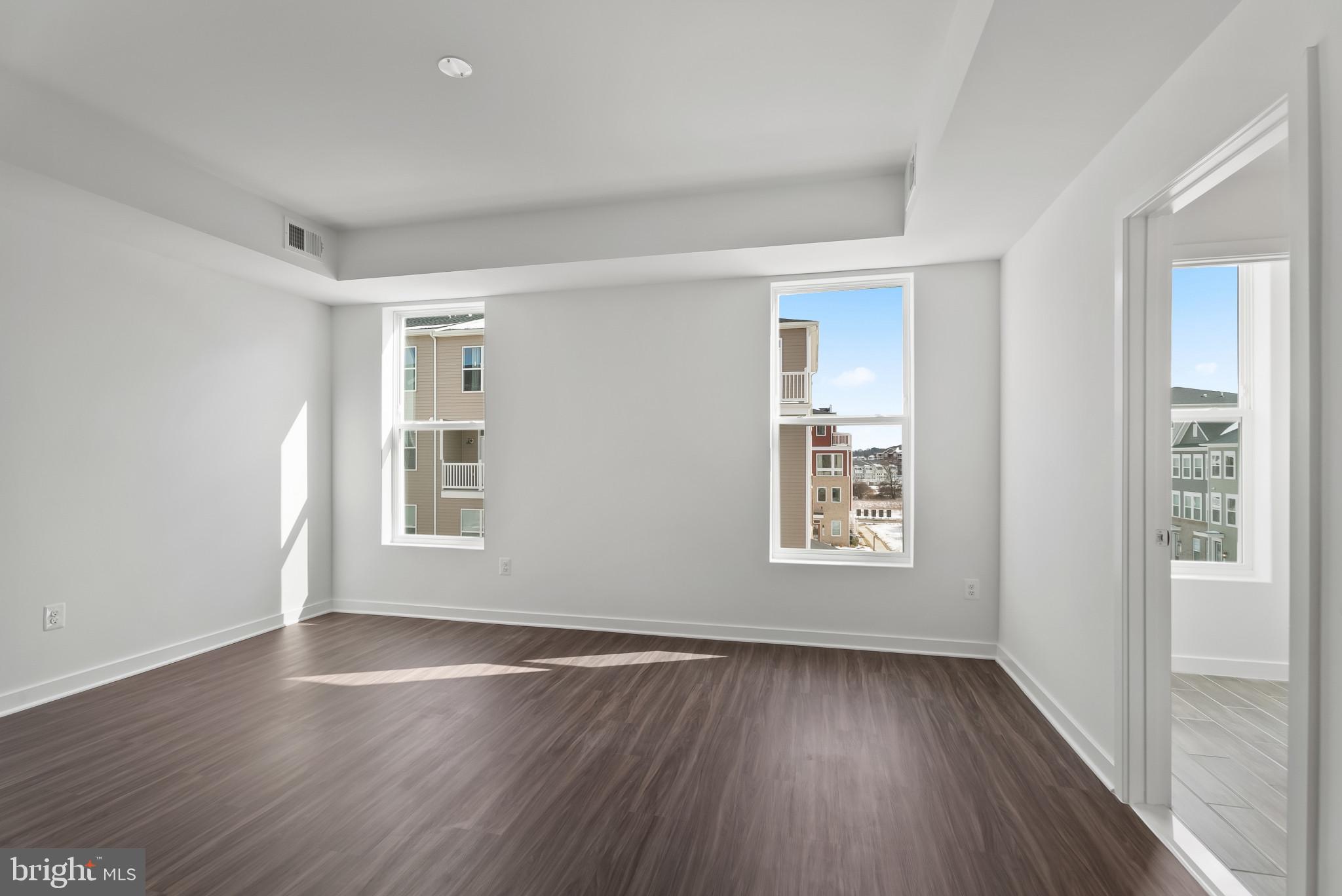 714 D Iron Frg Road Frederick, MD 21702 - Photo 26 of 47 an empty room with wooden floor and windows