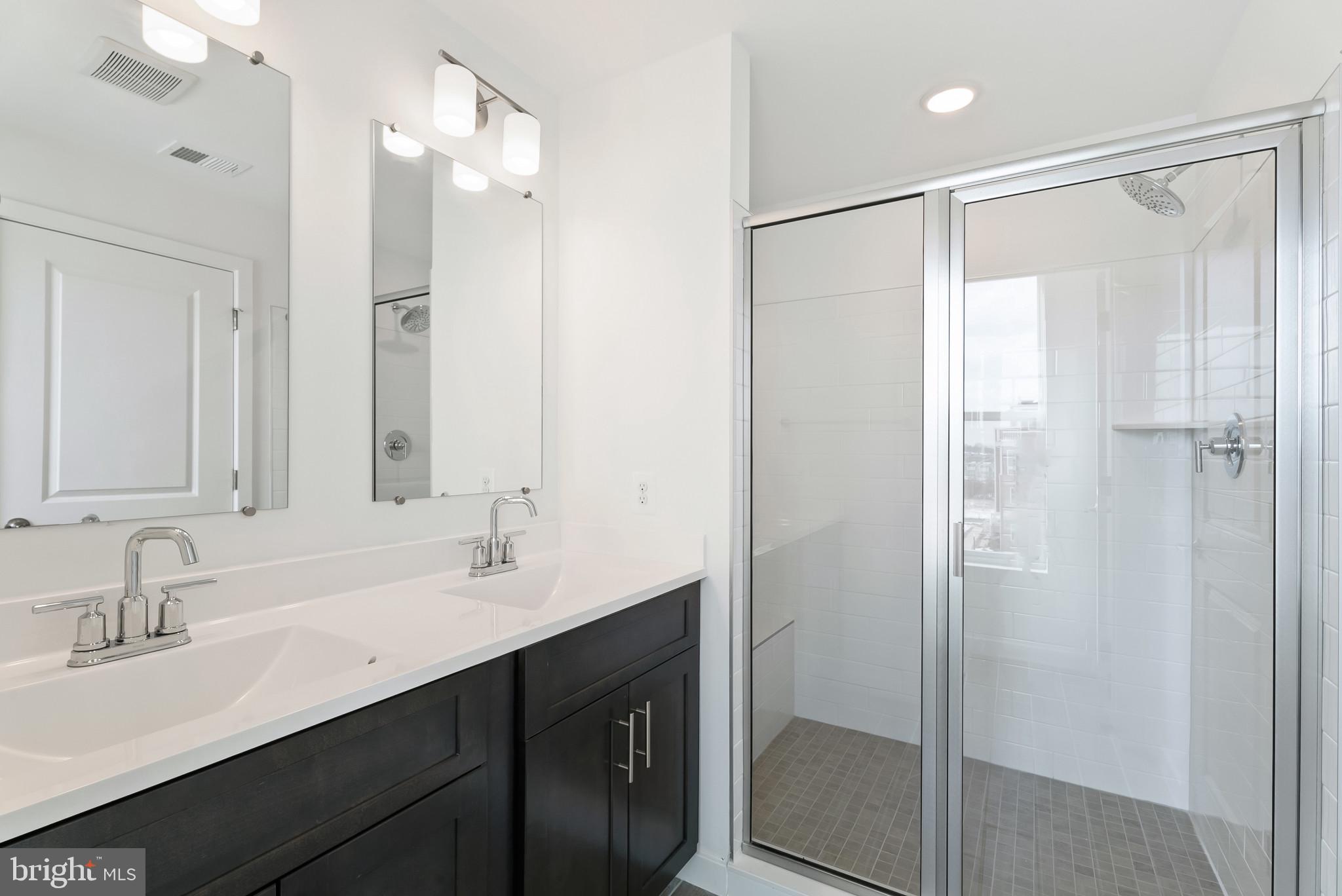 714 D Iron Frg Road Frederick, MD 21702 - Photo 27 of 47 a bathroom with a double vanity sink mirror and shower
