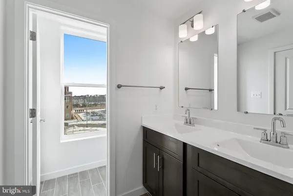 a bathroom with a sink double vanity and a mirror