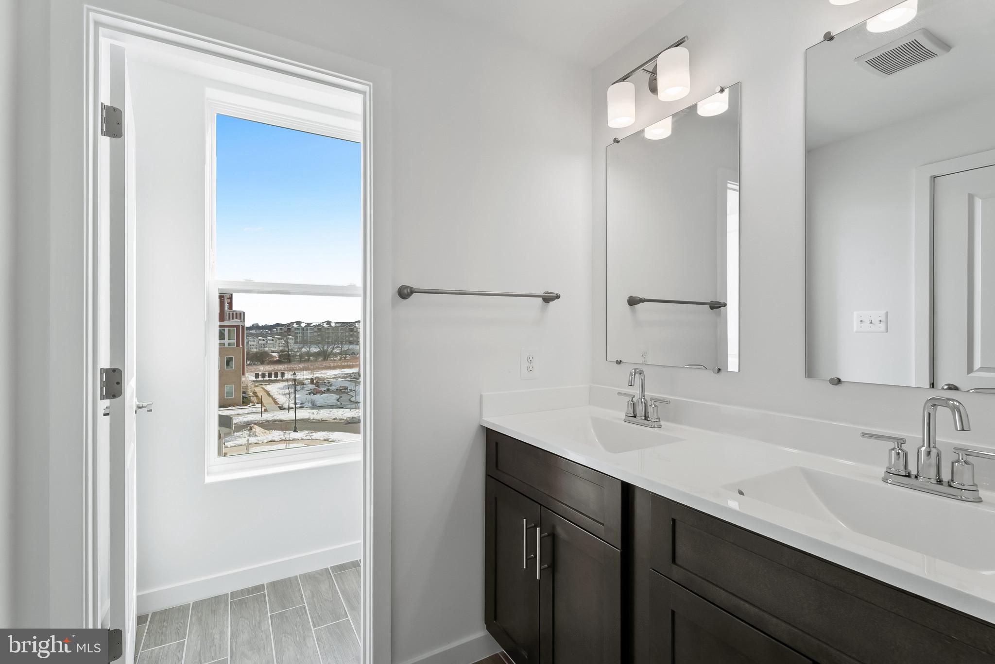 714 D Iron Frg Road Frederick, MD 21702 - Photo 28 of 47 a bathroom with a sink double vanity and a mirror