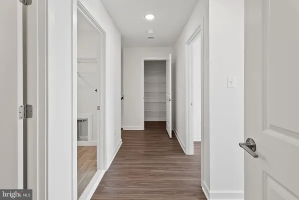 a view of a hallway with the wooden floor
