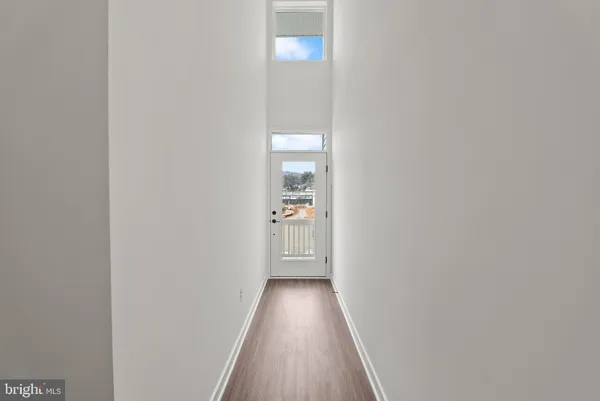 a view of a hallway with wooden floor
