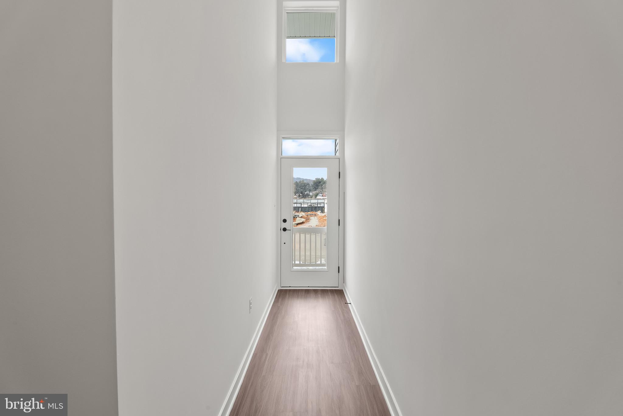 714 D Iron Frg Road Frederick, MD 21702 - Photo 3 of 47 a view of a hallway with wooden floor