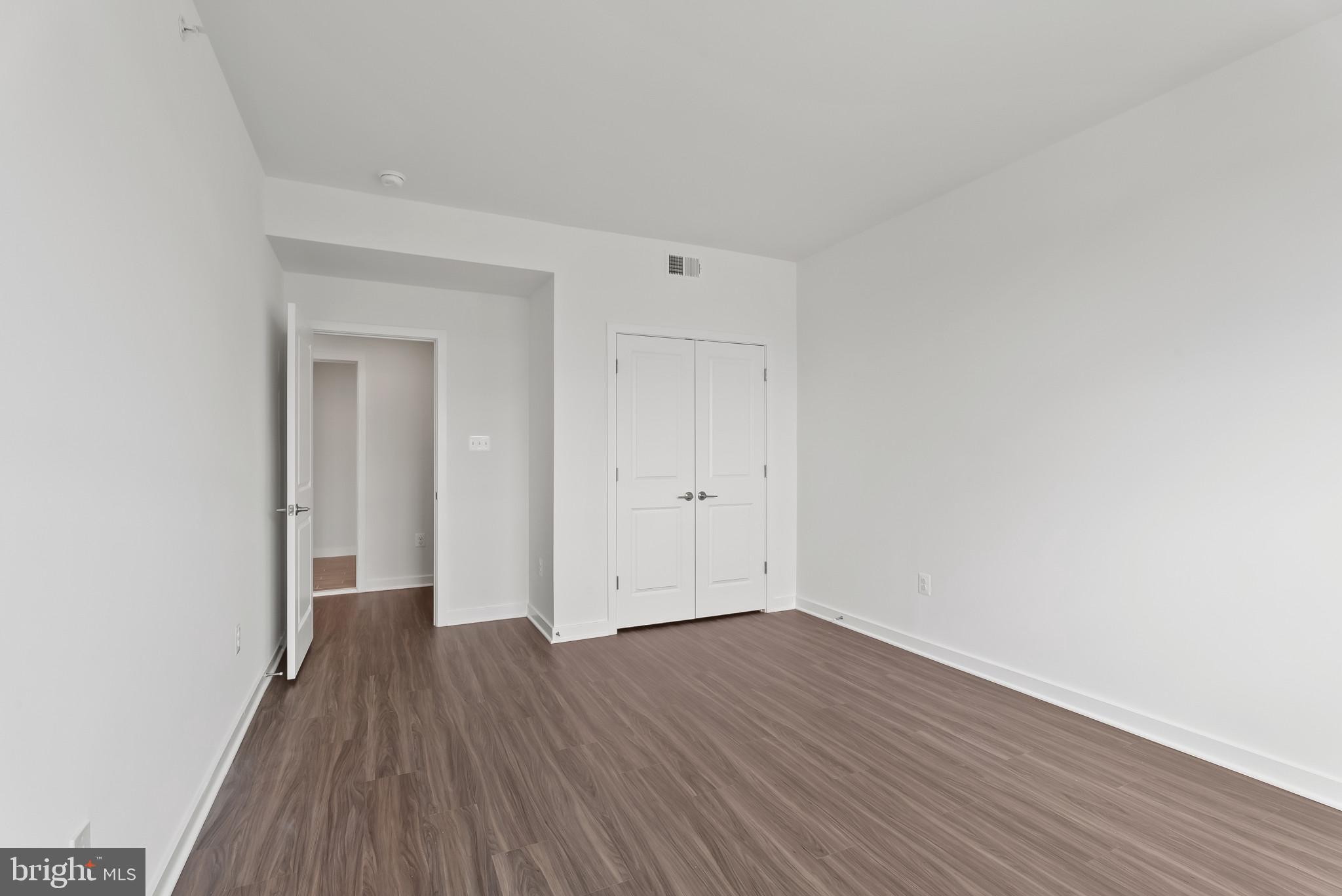 714 D Iron Frg Road Frederick, MD 21702 - Photo 32 of 47 a view of a room with wooden floor and white walls