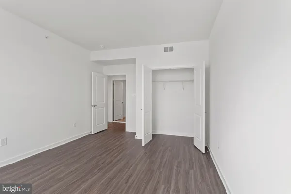 a view of a room with wooden floor