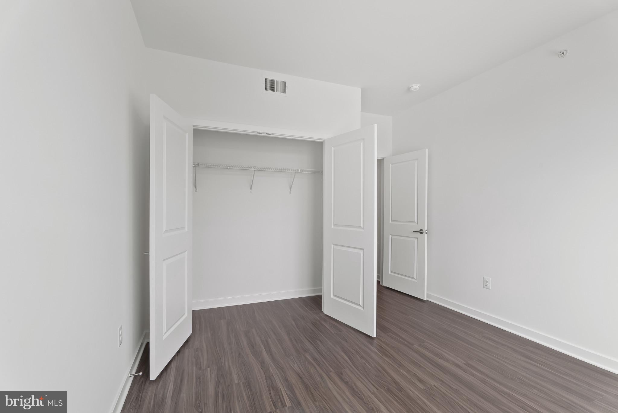 714 D Iron Frg Road Frederick, MD 21702 - Photo 36 of 47 a view of an empty room with wooden floor