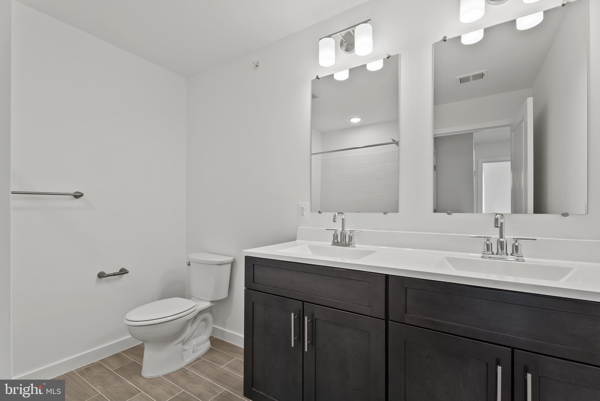 714 D Iron Frg Road Frederick, MD 21702 - Photo 39 of 47 a bathroom with a toilet a sink and mirror