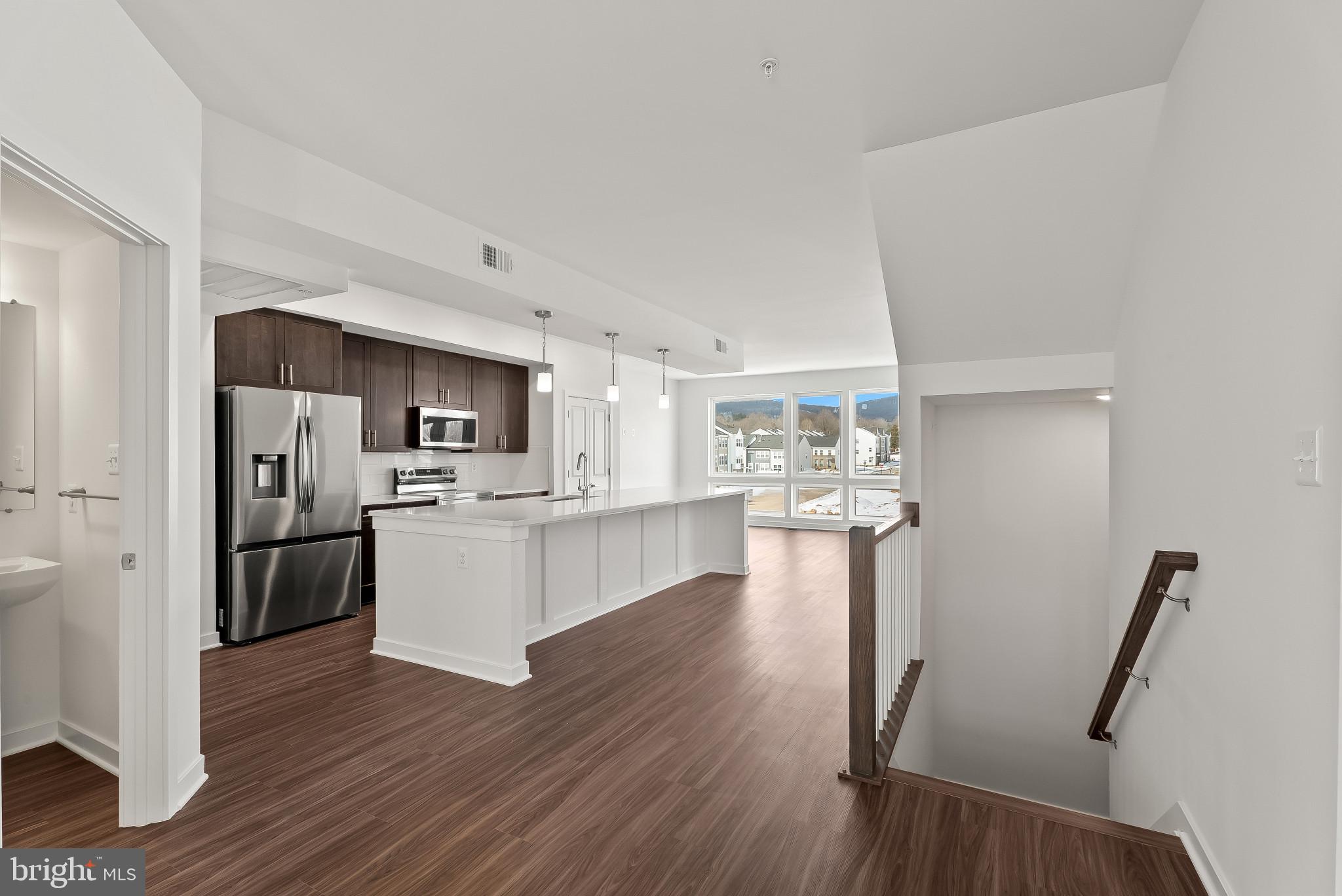 714 D Iron Frg Road Frederick, MD 21702 - Photo 5 of 47 a kitchen with a refrigerator and a wooden floor