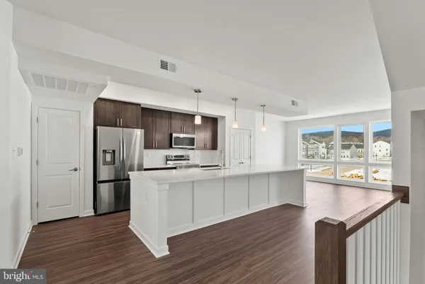 a kitchen with stainless steel appliances a refrigerator and a stove top oven