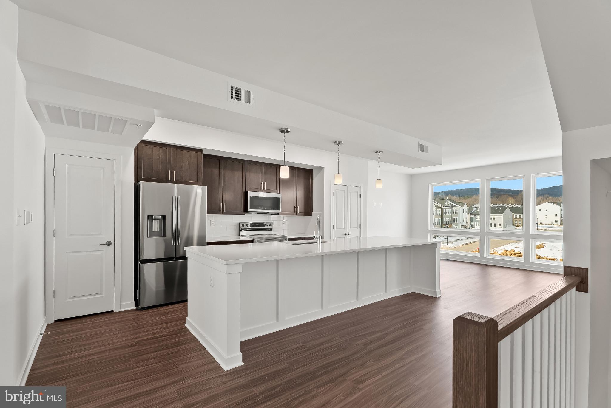 714 D Iron Frg Road Frederick, MD 21702 - Photo 6 of 47 a kitchen with stainless steel appliances a refrigerator and a stove top oven