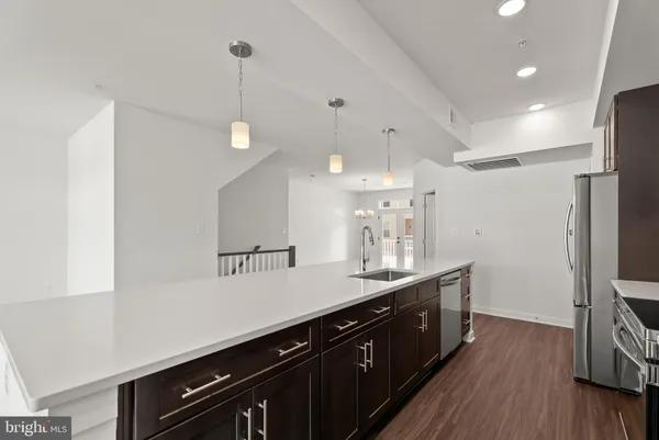 a kitchen with a sink and refrigerator