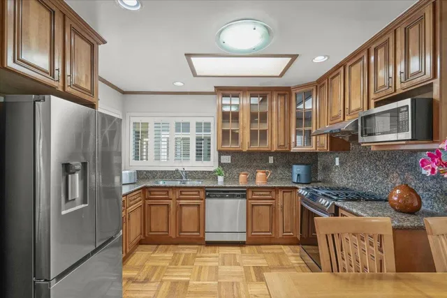 a kitchen with stainless steel appliances granite countertop a stove and a sink