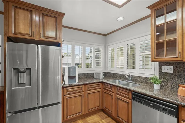 a kitchen with stainless steel appliances granite countertop a refrigerator and a sink