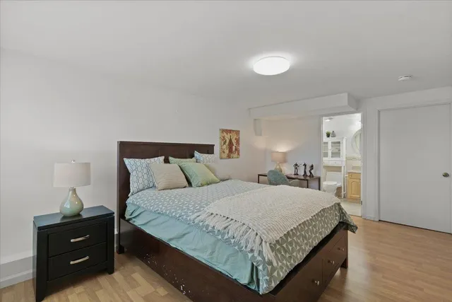 a bedroom with a bed and lamp on desk