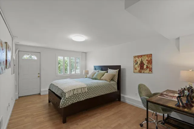 a bedroom with a bed and a desk