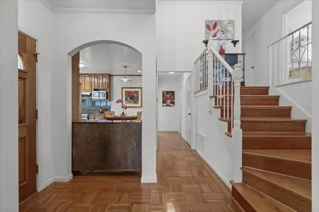 a view of entryway and hall with wooden floor