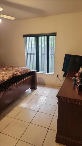 a bed room with a bed and a window