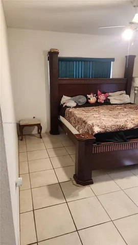 a bedroom with a bed and a shower