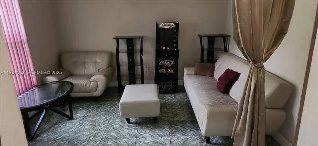 a living room with furniture and a mirror