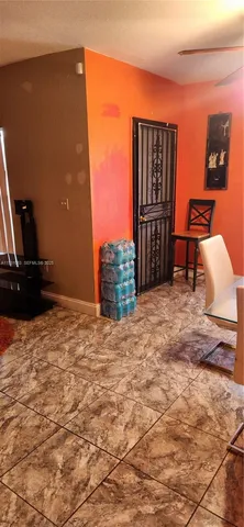 a bedroom with a bed and a lamp on dresser