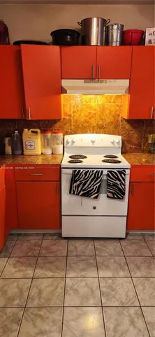a view of a kitchen with microwave and cabinets