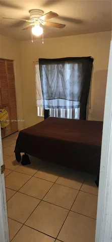 a bedroom with a bed and a cabinet