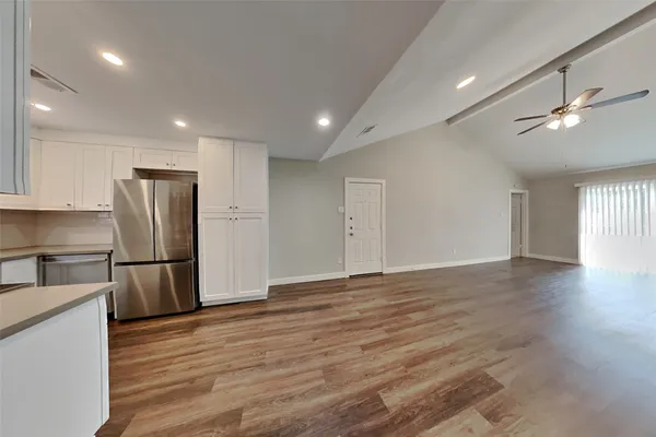 a view of kitchen with stainless steel appliances refrigerator microwave and stove