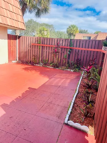 a backyard of a house with table and chairs