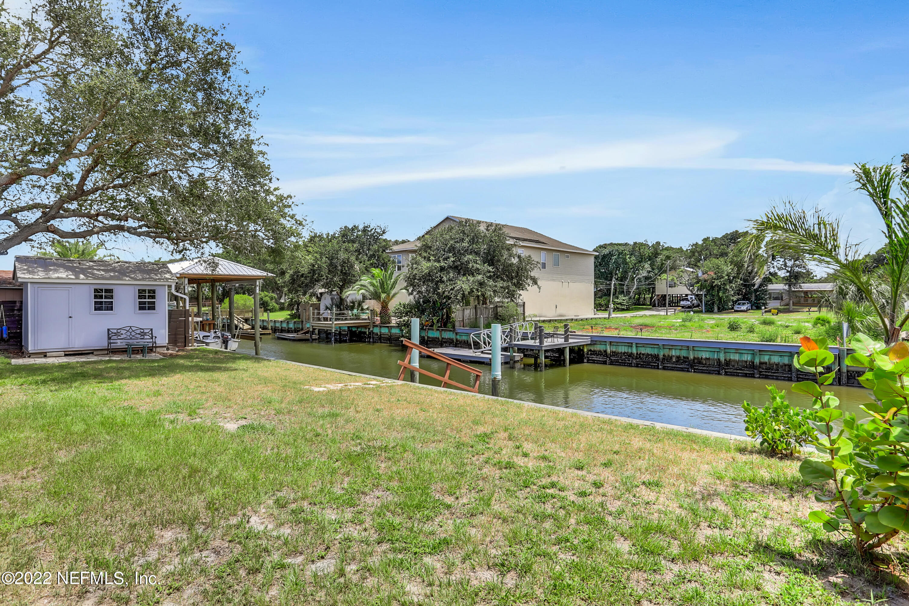 255 Villa Verda Road St. Augustine, FL 32080 - Photo 25 of 36 a view of a swimming pool with a garden and trees