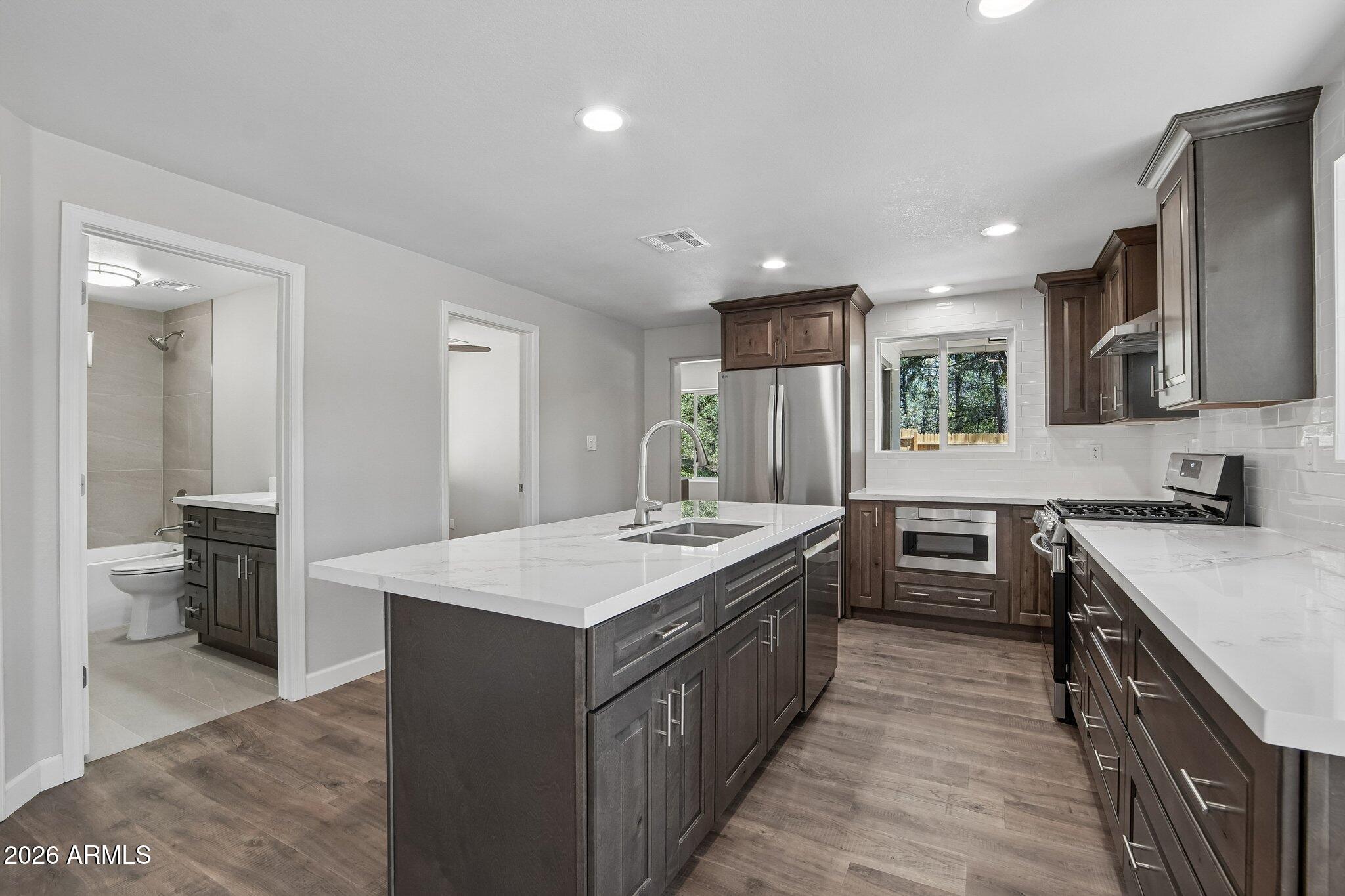 8324 Fossil Creek Road Pine, AZ 85544 - Photo 12 of 29 a kitchen with a stove sink and a refrigerator